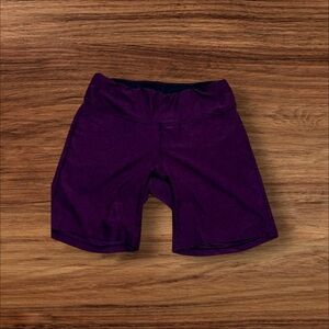 Mid-length purple New Balance bike shorts